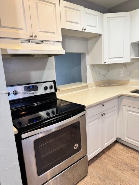 Coral Ridge Isles Fort Lauderdale, FL 33334 - Photo 16 of 17 a kitchen with granite countertop a stove microwave and sink