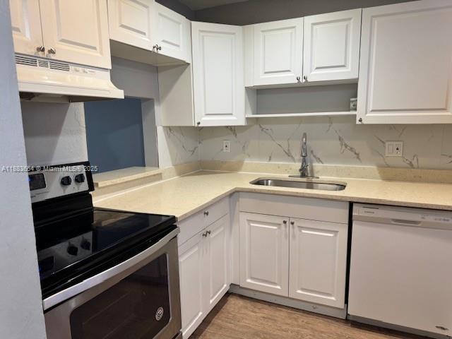 Coral Ridge Isles Fort Lauderdale, FL 33334 - Photo 17 of 17 a kitchen with a sink stove and cabinets