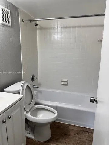 a bathroom with a toilet and a bathtub