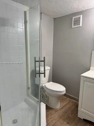 a white toilet sitting next to a bathroom sink