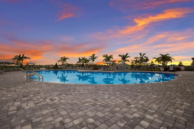 a view of a swimming pool with an outdoor seating