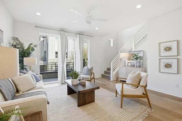 a living room with furniture and view of kitchen