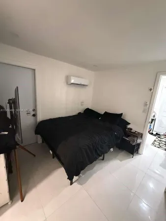 a black and white bed sitting in a bedroom