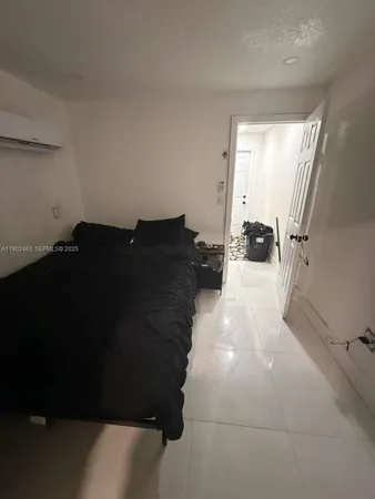 a view of a living room hardwood floor and a window