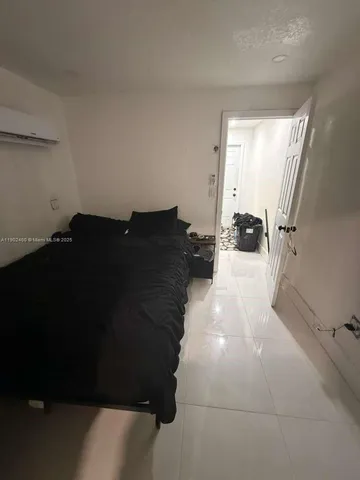 a view of a living room hardwood floor and a window