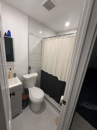 a bathroom with a toilet a sink and a mirror