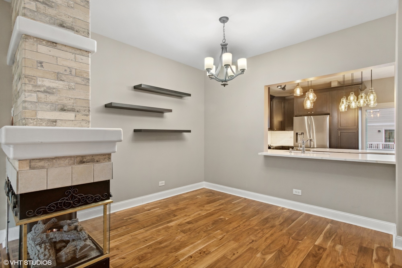 3443 Ravinia Circle Aurora, IL 60504 - Photo 12 of 36 a view of a room with a chandelier and wooden floor