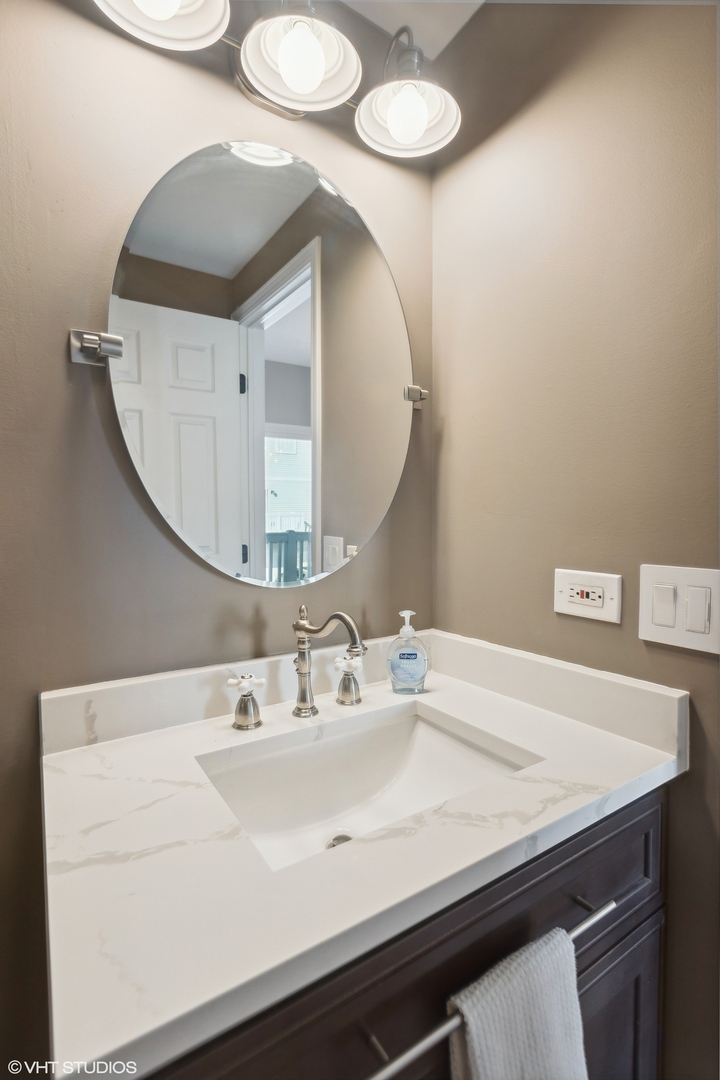 3443 Ravinia Circle Aurora, IL 60504 - Photo 26 of 36 a bathroom with a sink and a mirror