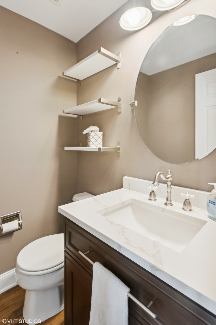 3443 Ravinia Circle Aurora, IL 60504 - Photo 27 of 36 a bathroom with a sink a toilet and mirror