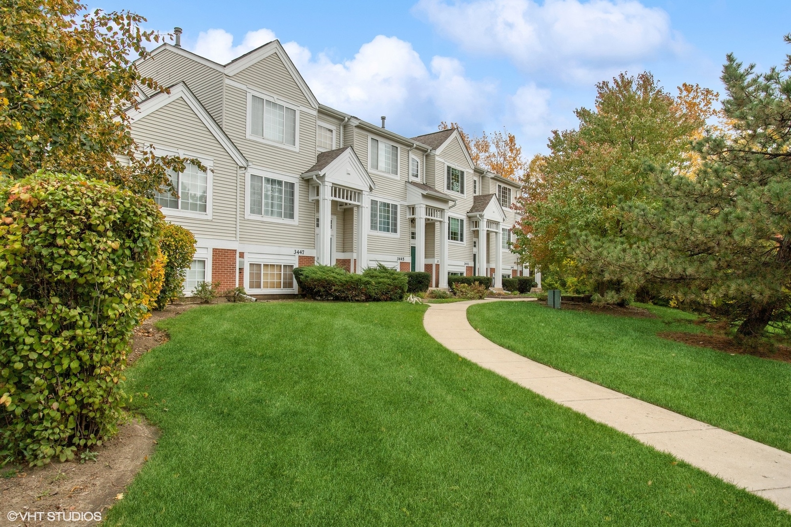 3443 Ravinia Circle Aurora, IL 60504 - Photo 4 of 36 a view of a white house next to a yard with big trees