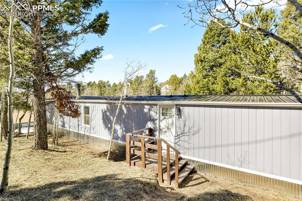 358 Fern Road Woodland Park, CO 80863 - Photo 13 of 17 a view of a swimming pool with a patio and wooden fence