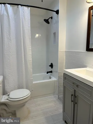 a bathroom with a toilet a sink and bathtub