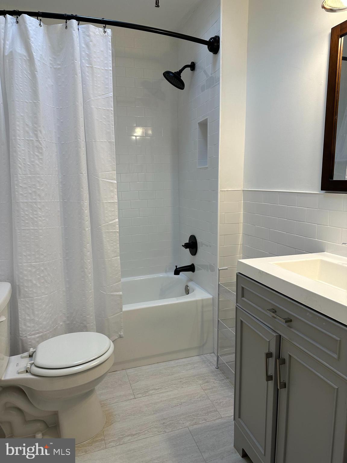 5928 Loretto Avenue Philadelphia, PA 19149 - Photo 2 of 9 a bathroom with a toilet a sink and bathtub