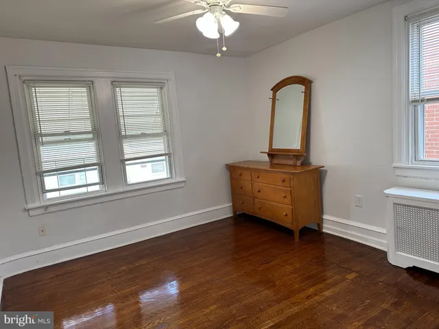 a view of room with window and wooden floor