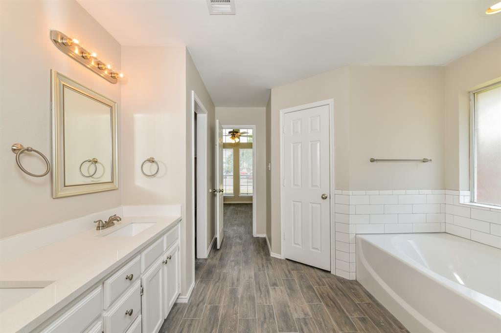 1772 Independence Road Blue Mound, TX 76131 - Photo 11 of 16 a bathroom with a sink a mirror and a bathtub