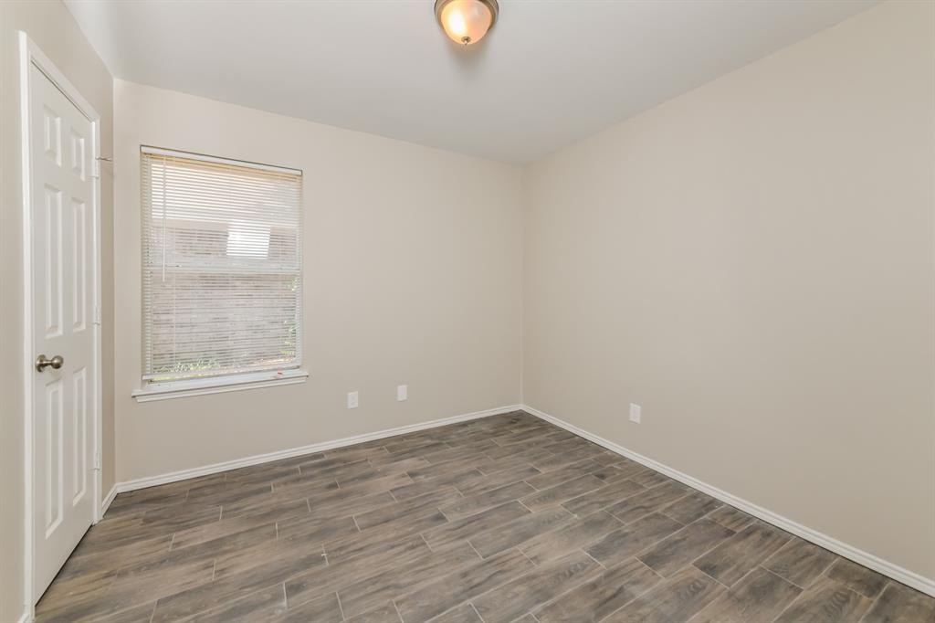 1772 Independence Road Blue Mound, TX 76131 - Photo 12 of 16 a view of an empty room with wooden floor and a window