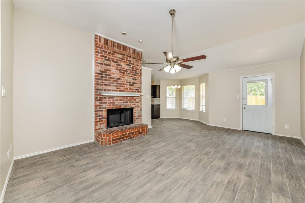 1772 Independence Road Blue Mound, TX 76131 - Photo 3 of 16 a view of a livingroom with a fireplace and window