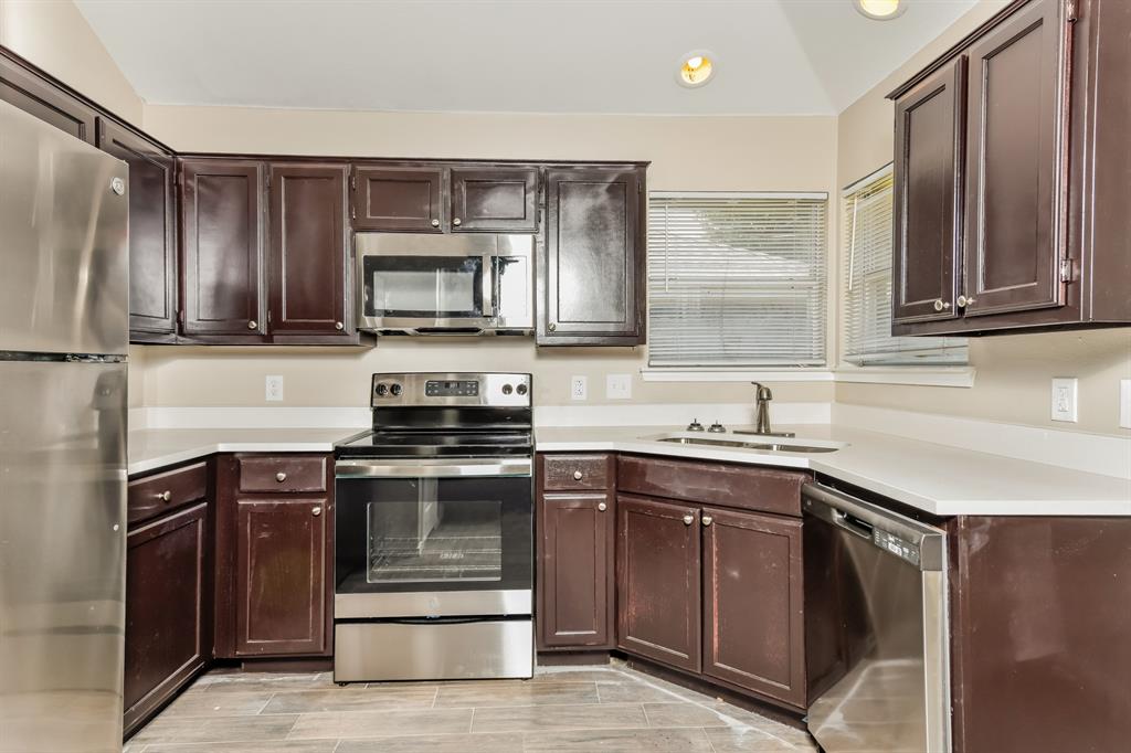 1772 Independence Road Blue Mound, TX 76131 - Photo 6 of 16 a kitchen with a sink stove and cabinets