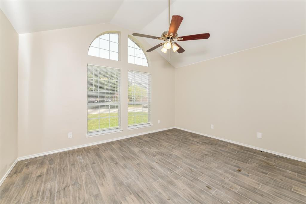 1772 Independence Road Blue Mound, TX 76131 - Photo 7 of 16 an empty room with wooden floor fan and windows