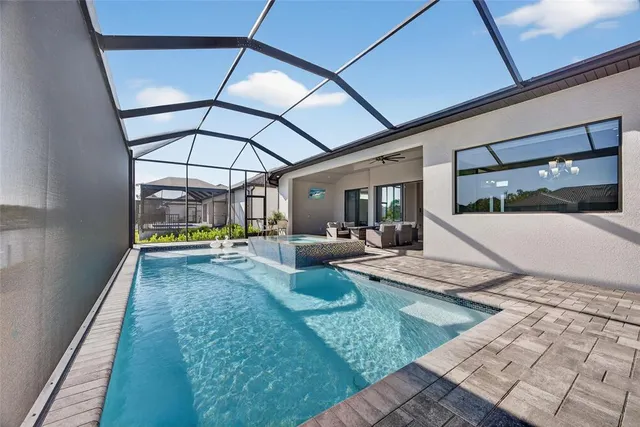 a view of a swimming pool with seating area