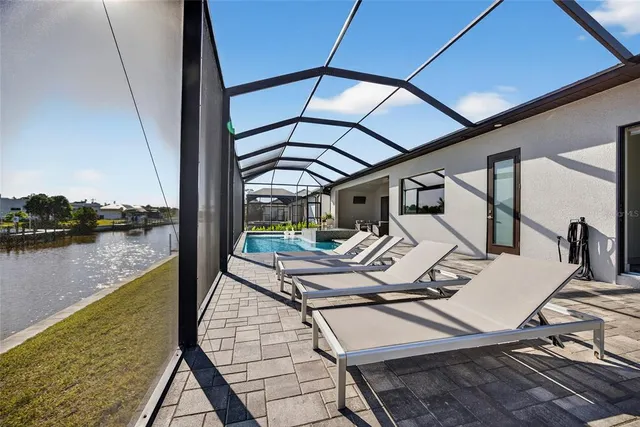 a view of swimming pool with outdoor seating