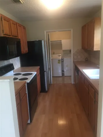 a kitchen with a refrigerator and a sink