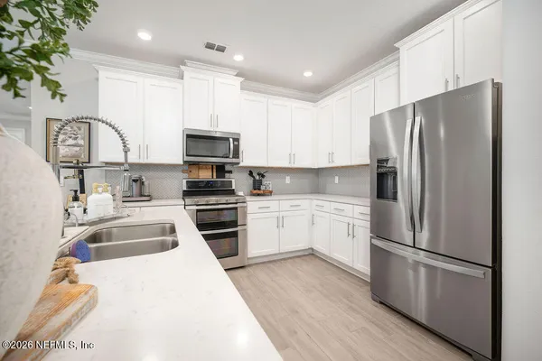 a kitchen with a refrigerator sink and microwave