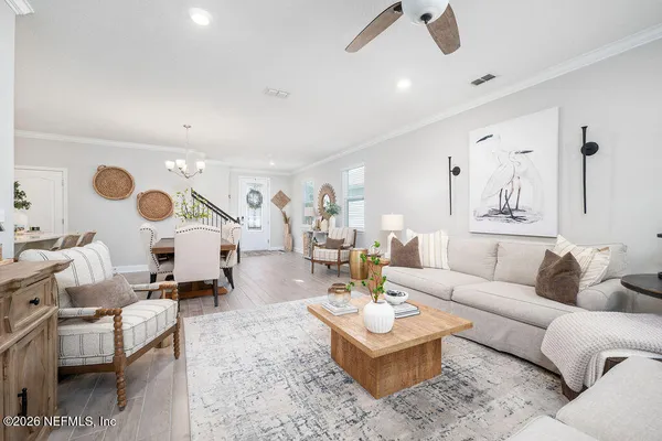 a living room with furniture and view of kitchen
