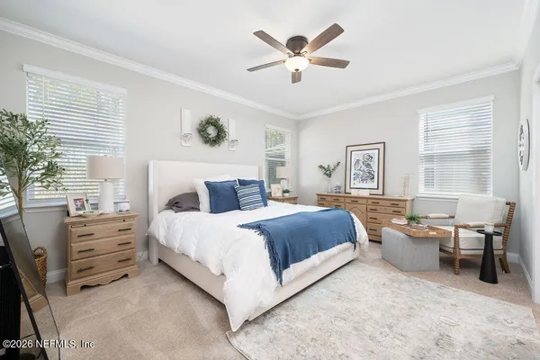 a bedroom with a bed wooden floor and window