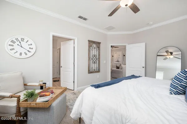 a bedroom with a bed and a chandelier