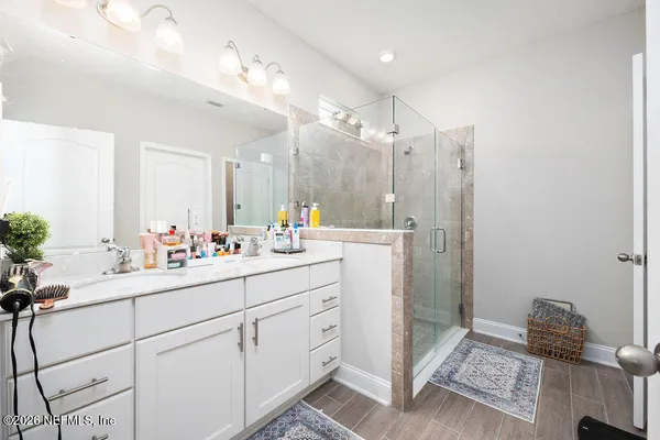 a bathroom with a sink a mirror and a shower