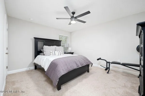 a bedroom with a bed and a desk