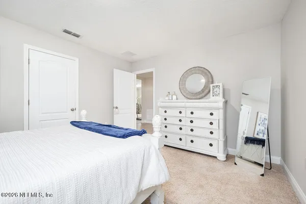 a bedroom with a bed and a dresser