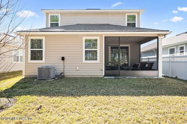 a view of a house with backyard and porch
