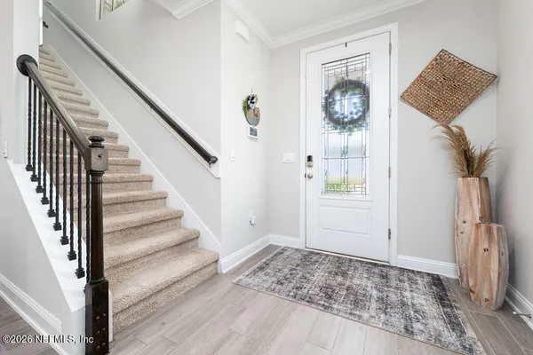 a view of an entryway with wooden floor