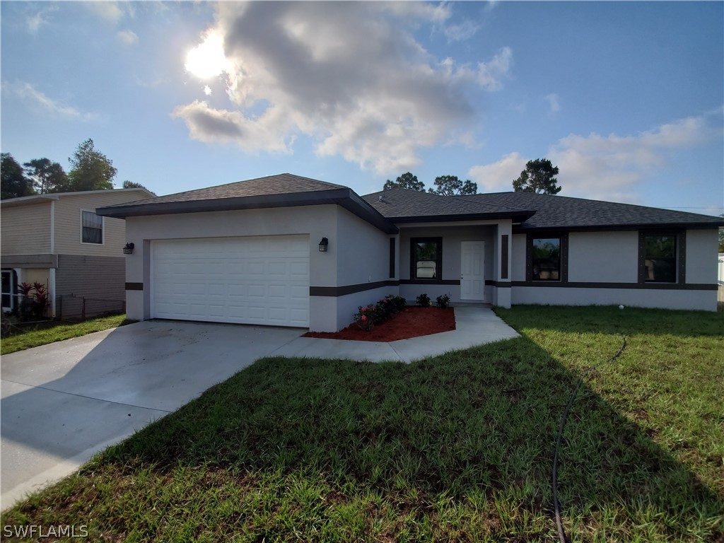 8072 Anhinga Road Fort Myers, FL 33967 - Photo 1 of 16 a front view of a house with garden