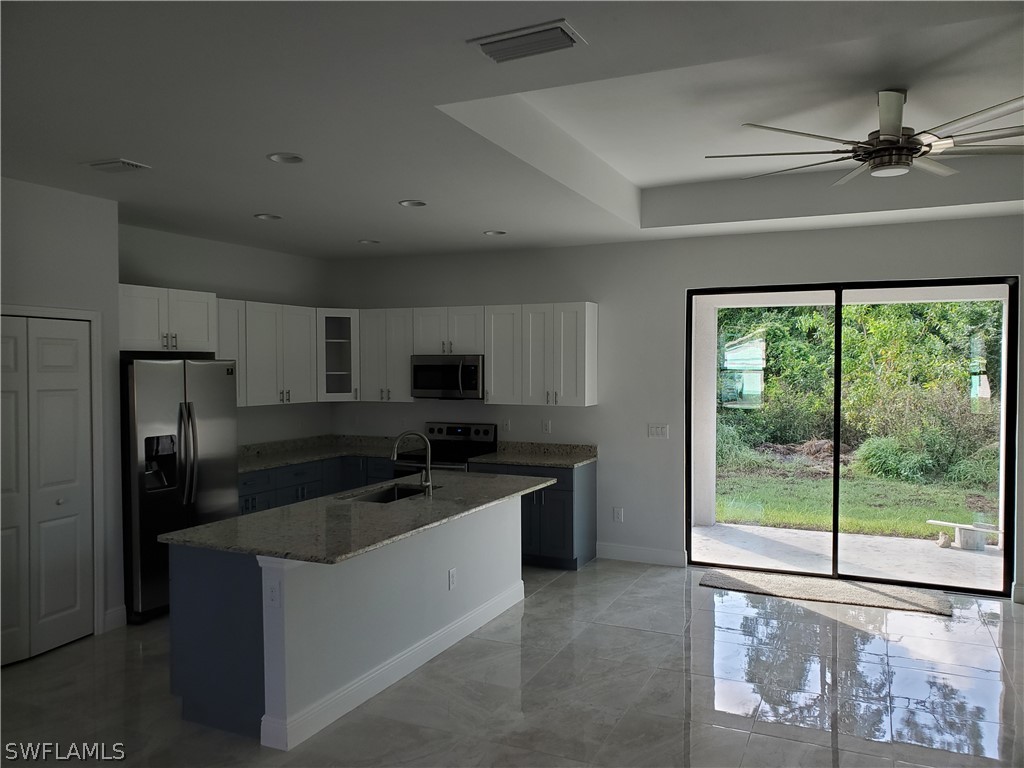 8072 Anhinga Road Fort Myers, FL 33967 - Photo 2 of 16 a kitchen with stainless steel appliances granite countertop a refrigerator and a sink