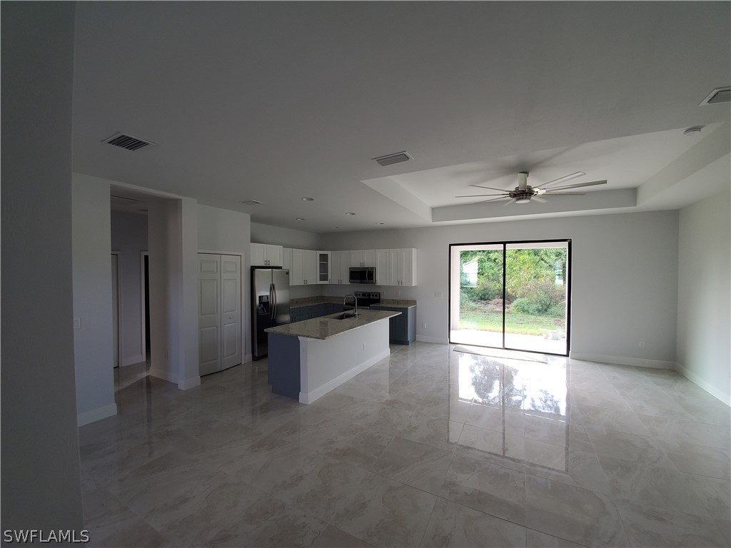 8072 Anhinga Road Fort Myers, FL 33967 - Photo 4 of 16 a kitchen with granite countertop a refrigerator and a sink