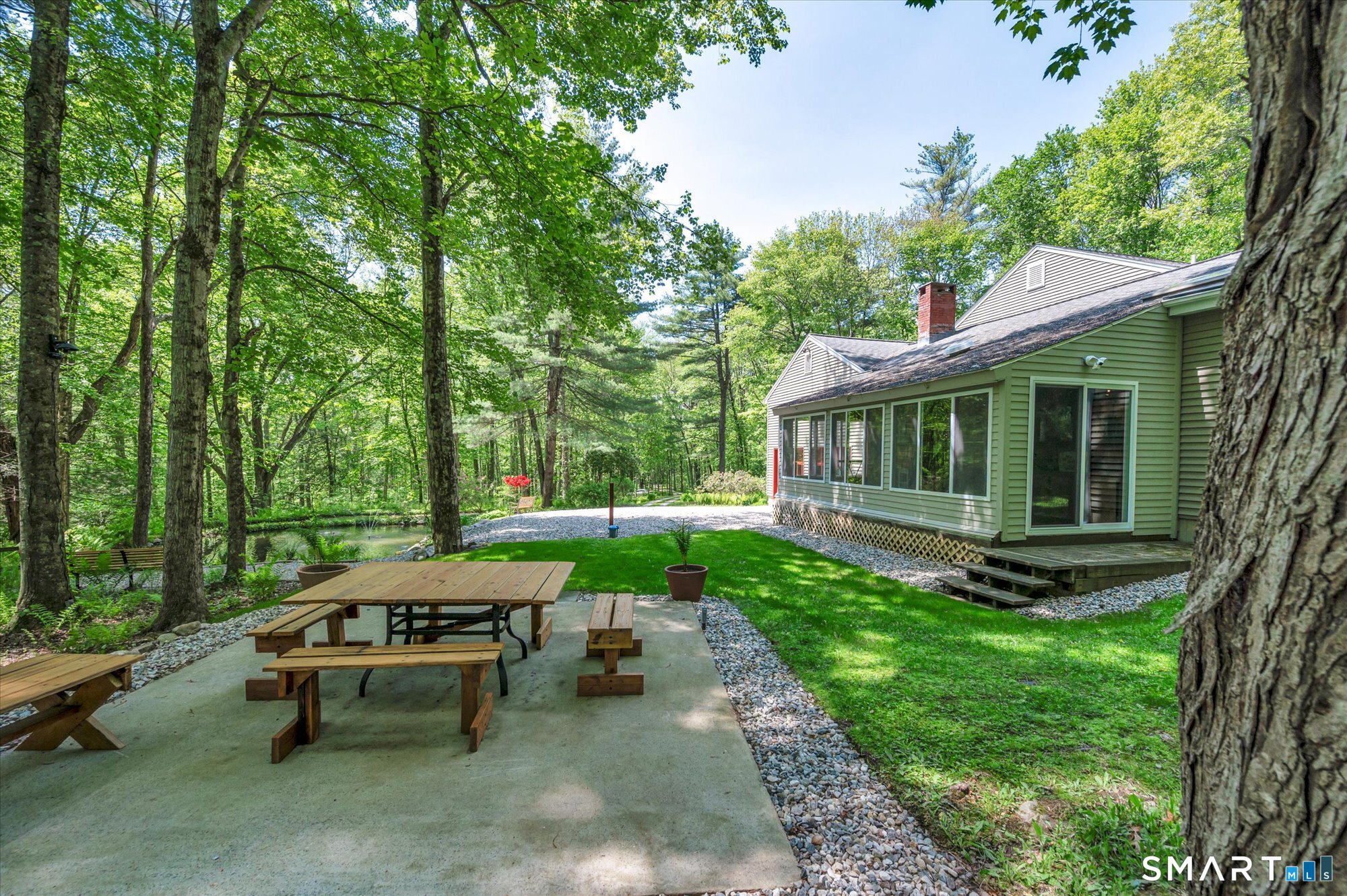 59 Indian Hill Road Canton, CT 06019 - Photo 30 of 39 a view of a house with backyard sitting area and garden