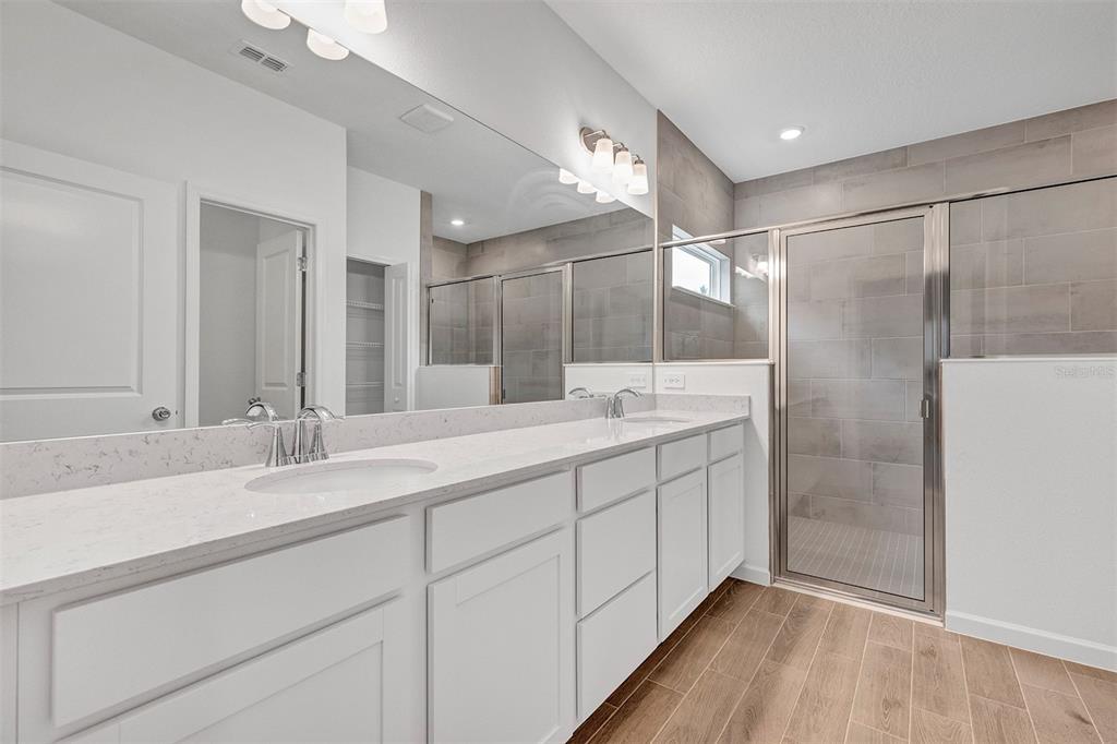 19426 Southwest 79th Street Dunnellon, FL 34432 - Photo 12 of 34 a bathroom with a double vanity sink and mirror