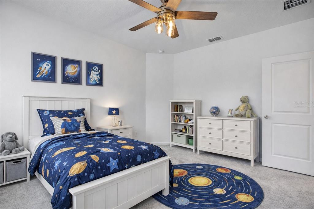 19426 Southwest 79th Street Dunnellon, FL 34432 - Photo 16 of 34 a bedroom with a bed and a dresser