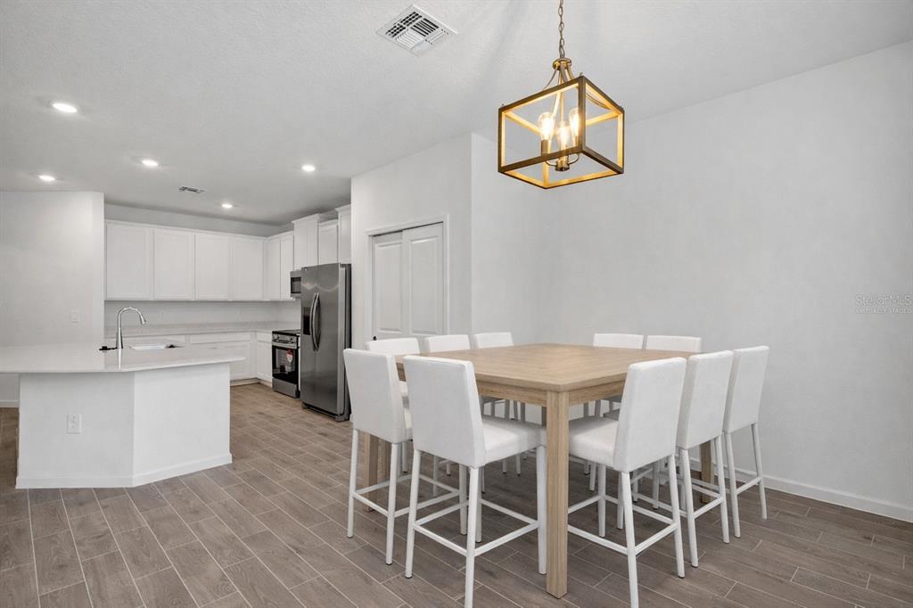 19426 Southwest 79th Street Dunnellon, FL 34432 - Photo 7 of 34 a view of a dining room with furniture and wooden floor