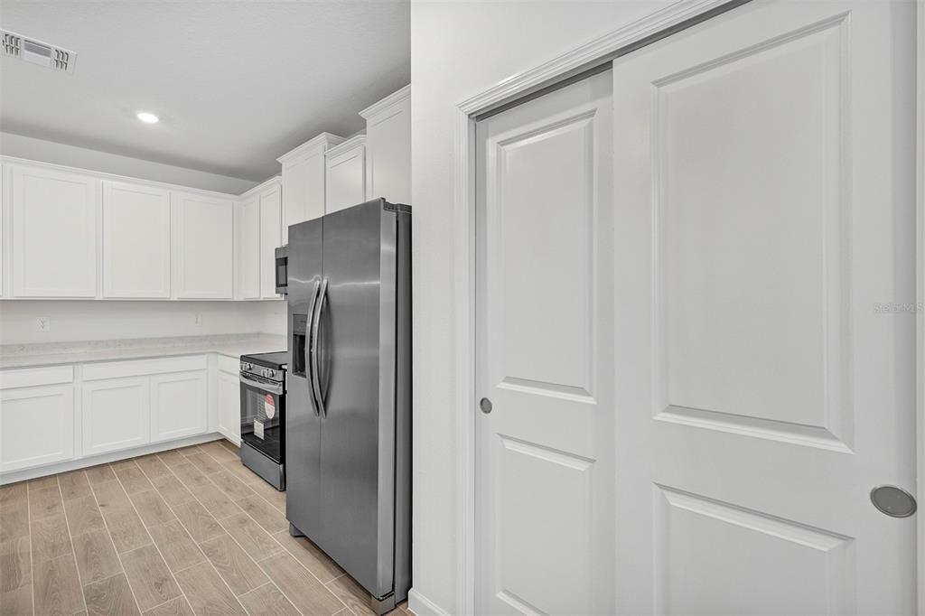 19426 Southwest 79th Street Dunnellon, FL 34432 - Photo 8 of 34 a kitchen with a refrigerator and cabinets
