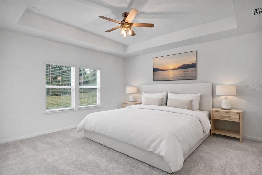 19426 Southwest 79th Street Dunnellon, FL 34432 - Photo 10 of 34 a bedroom with a bed and a ceiling fan