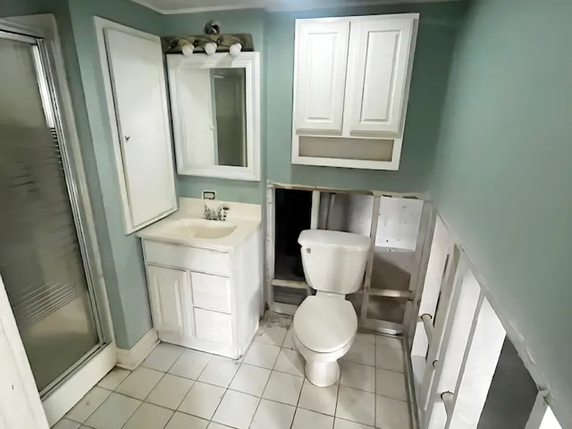 a bathroom with a toilet sink and mirror