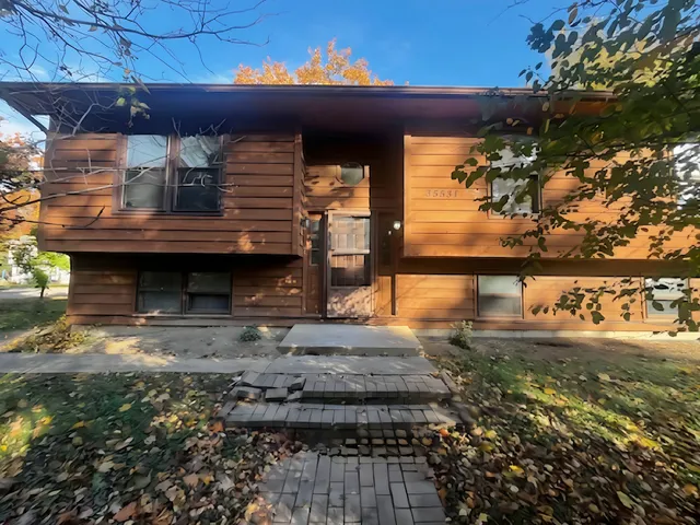 a view of a backyard of a house with a fountain