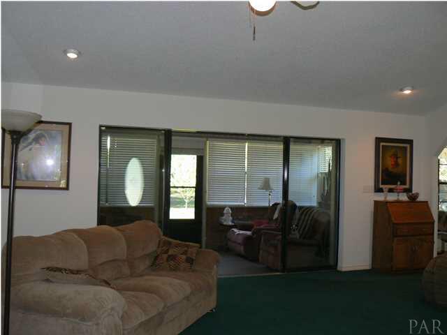 6545 Martin Road Milton, FL 32570 - Photo 7 of 18 Partial view of living room looking into Florida room, notice the 16' slider doors (roll out of sight into wall) really opens up the space.
