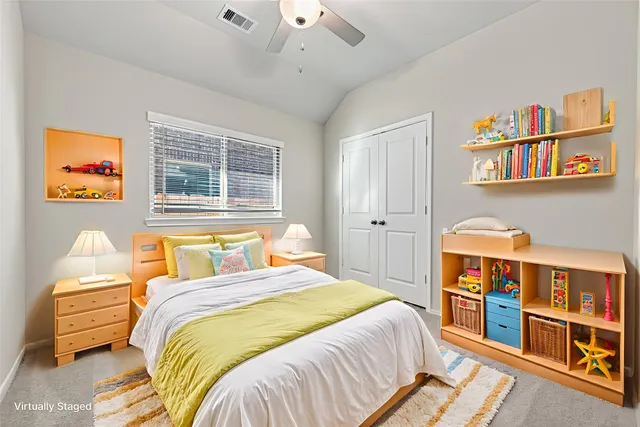 a bedroom with a bed a dresser and a book shelf