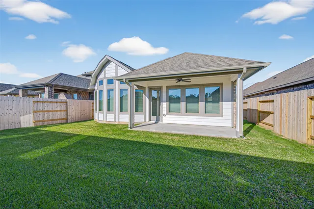 a view of a house with a backyard