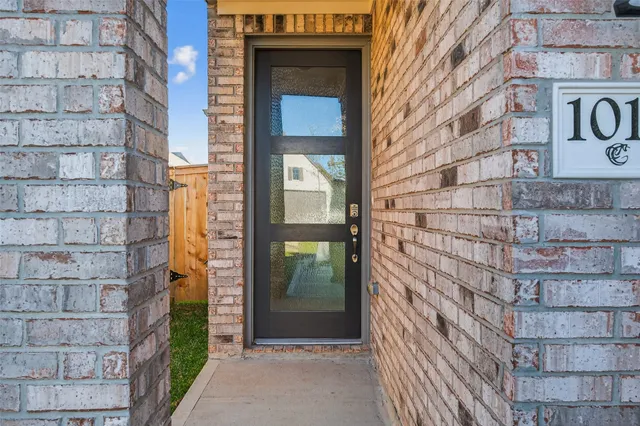a brick building with a door and a window